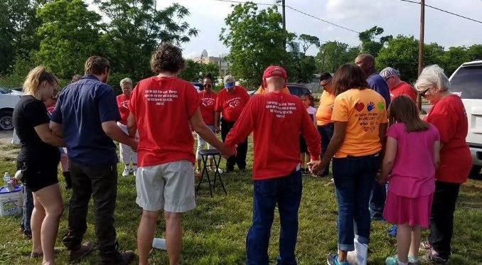 Volunteers in circle prayer