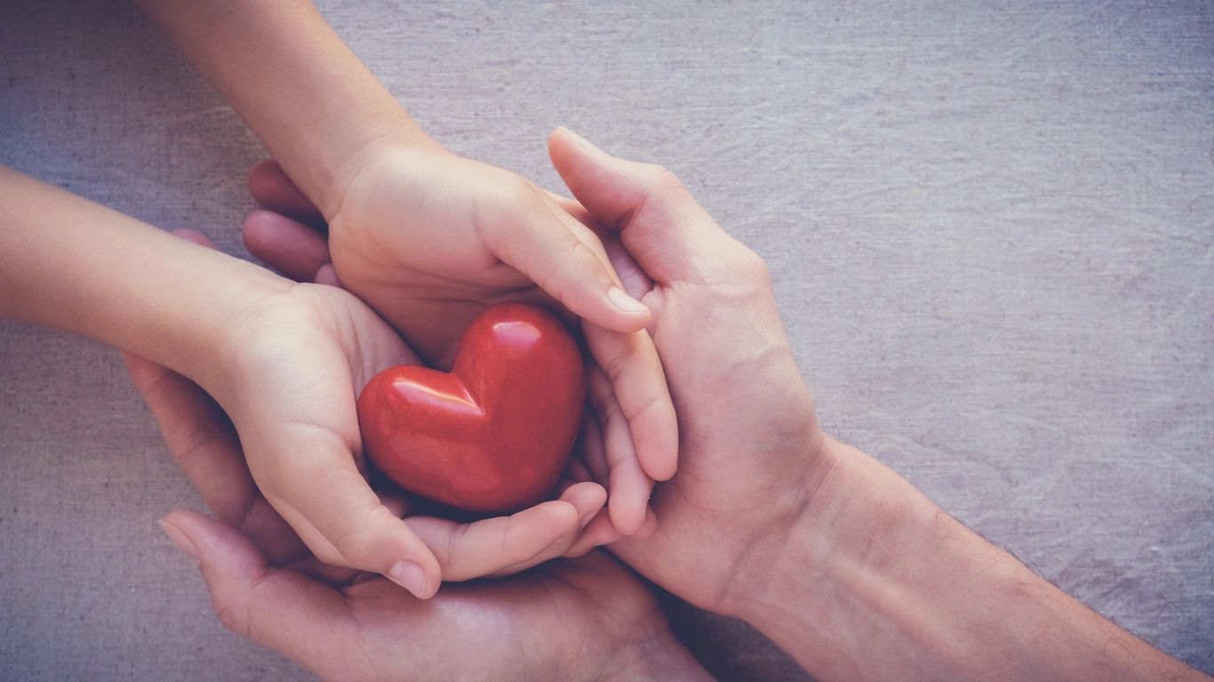 Hands holding a red heart